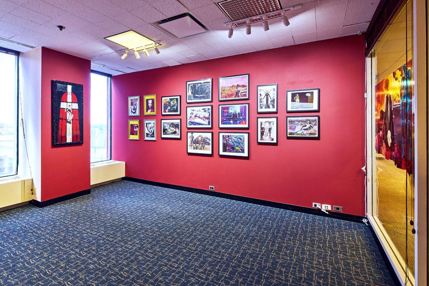 Installation view of “Tales From The Jesus Cafe”: framed collage works on a red wall at The Spring Break Art Show NYC, Booth B38